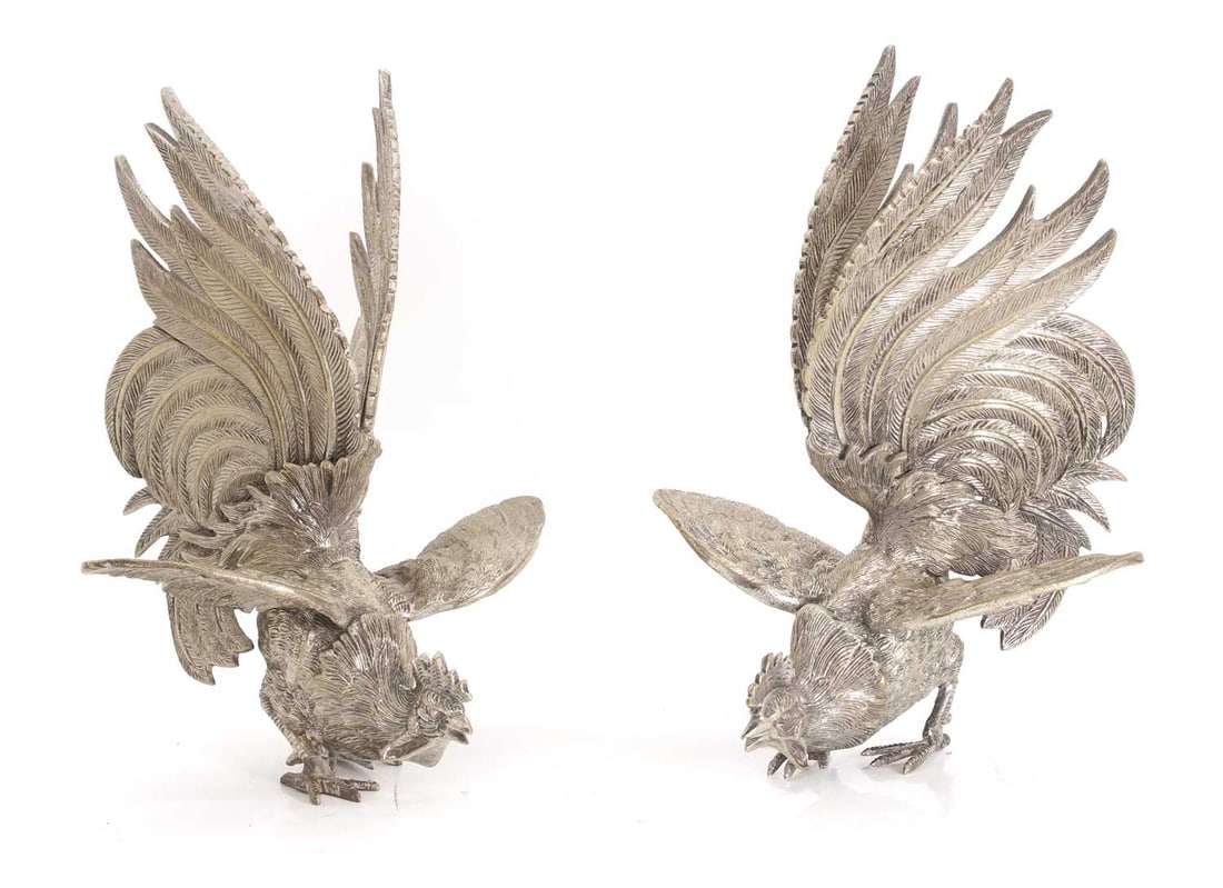 A pair of silver-plated fighting cocks, 20th century,: A pair of silver-plated fighting cocks, 20th century, both modelled in fighting position 16cm wide, 25cm high 2 Condition Report: Slight wobble when on a flat surface. Rubbing to the surface. The