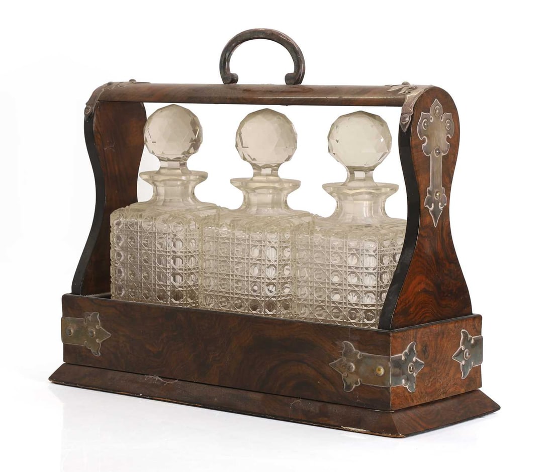 A Victorian walnut cased tantalus, early 20th century,: A Victorian walnut cased tantalus, early 20th century, with three glass decanters 43cm wide, 16cm deep, 36cm high Condition Report: mechanism amd lock do not work or turn. Bottles stuck in the