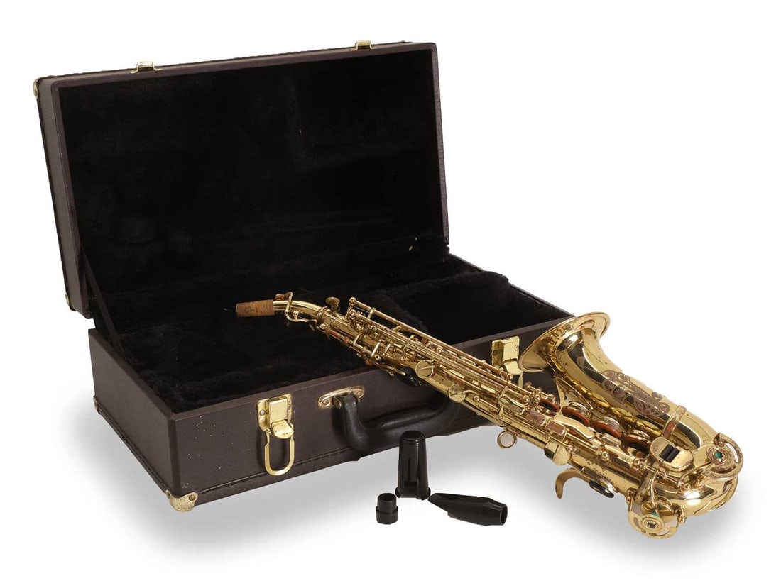 An El Rharl Alto saxophone,: An El Rharl Alto saxophone, with mother of pearl inlaid buttons marked as '300 Series', cased 52cm long Condition Report: A collection of dust and dirt and some rusting to the frame.