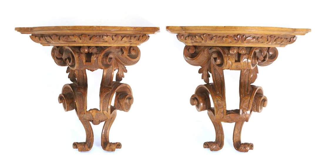 A pair of walnut wall brackets, late 19th century, possibly French,: A pair of walnut wall brackets, late 19th century, possibly French, the carved underside with foliate details supporting the top platform with acanthus leaf decoration 35cm wide, 27cm deep, 33cm high