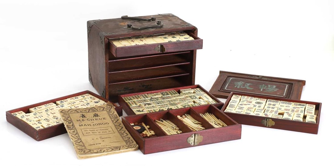 A majong set, early 20th century, Chinese,: A majong set, early 20th century, Chinese, with bamboo and bone counters, housed within a pine case 25cm wide, 16cm deep, 18cm high (qty.) Condition Report: case bashed and with damages and losses,