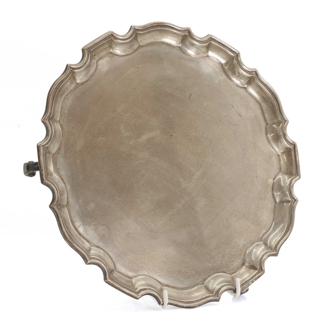 A modern silver salver,: A modern silver salver, by Asprey & Co Ltd, Birmingham, 1933, with a piecrust border, on scroll feet 25,5cm diameter, 20.4ozt