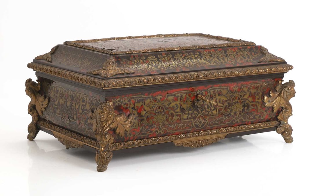 A Boulle work and metal mounted casket, 19th / 20th century,: A Boulle work and metal mounted casket, 19th / 20th century, with elaborate gilt brass detailing, corner masks, and detaield centre pictorals of musicians and dancer, 33cm wide, 23.5cm deep, 14.5cm hi