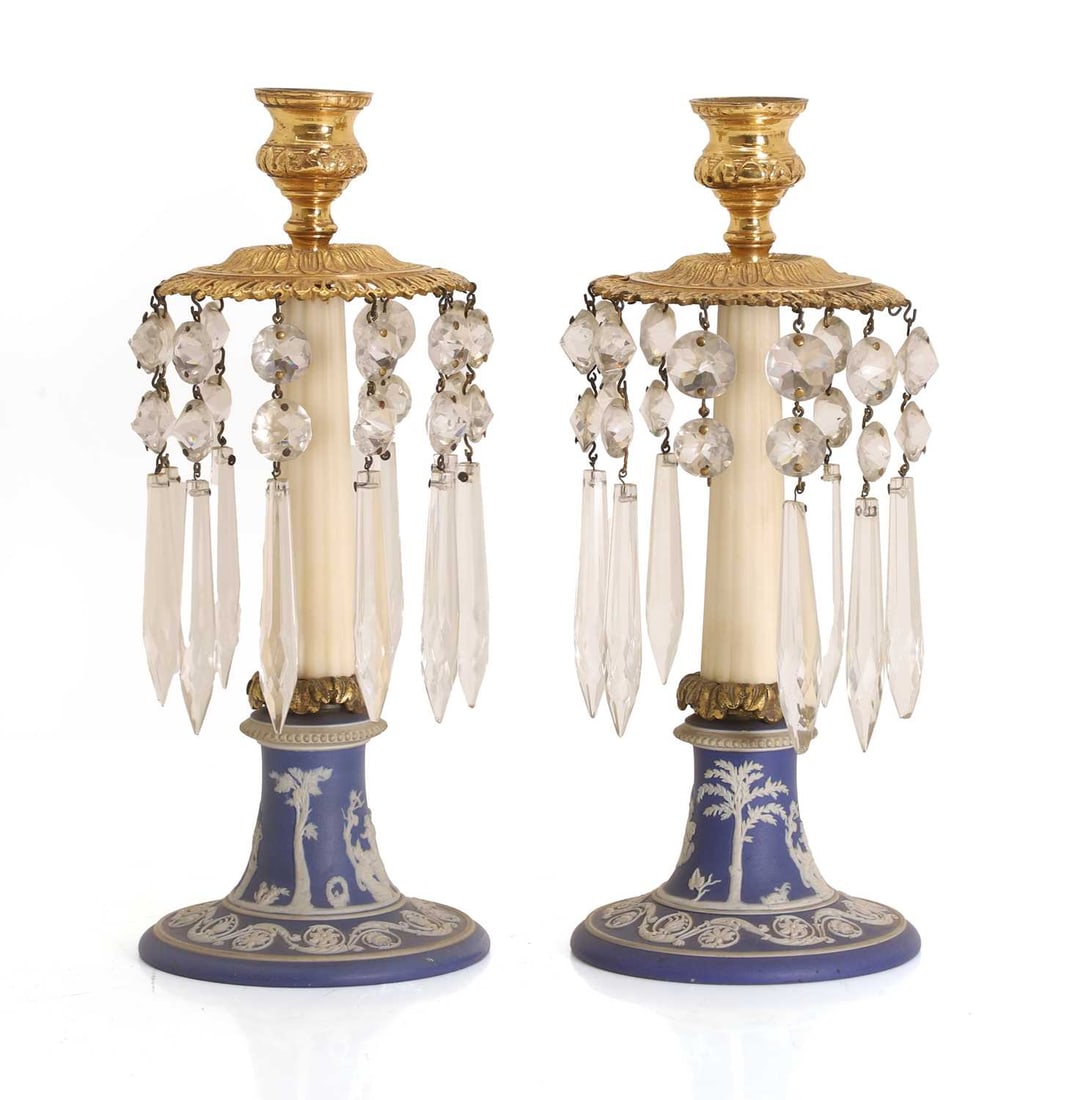A pair of Wedgwood jasperware, gilt lacquered brass and glass lustres, 19th century,: A pair of Wedgwood jasperware, gilt lacquered brass and glass lustres, 19th century, depicting classical scenes to the base with a pierced collar surmounting the shaped column 11cm wide, 27cm high 2 C