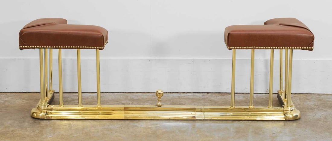 Extending brass club fender, of recent manufacture,: Extending brass club fender, of recent manufacture, with red leather padded section, with brass studded detailing, 144cm wide 46cm deep, 48cm high