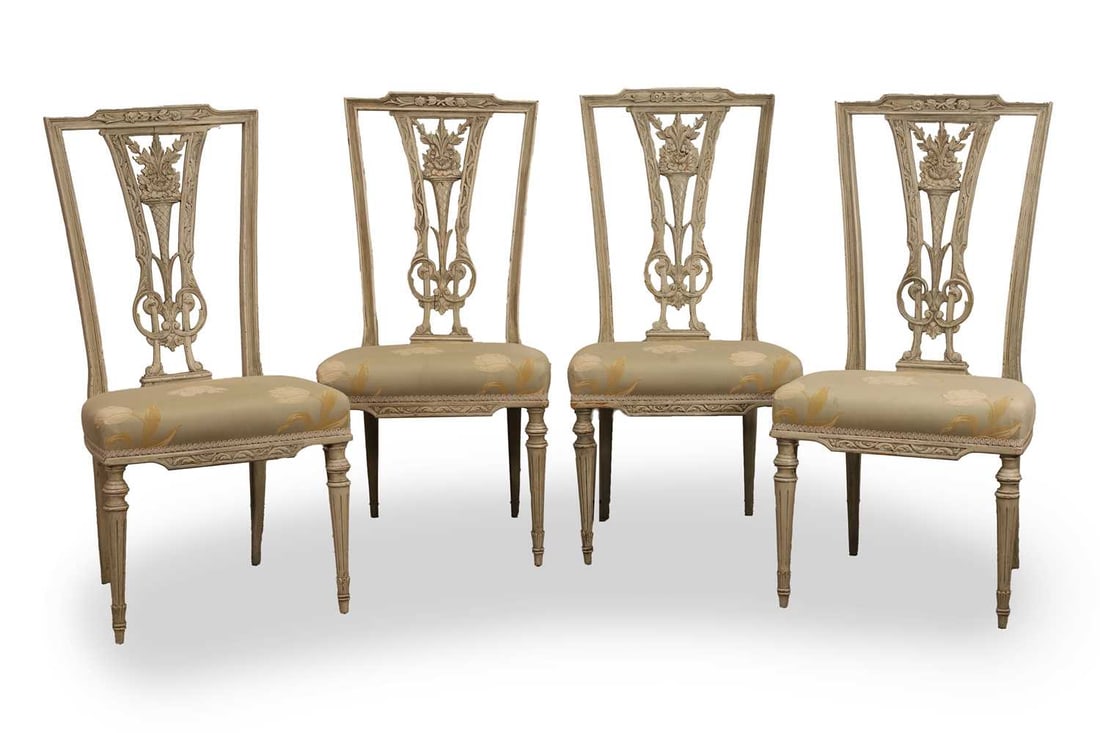 A set of four Louis XVI-style painted wooden side chairs, early 20th century, French,: A set of four Louis XVI-style painted wooden side chairs, early 20th century, French, each pierced splat with floral decoration, above a square seat upholstered in floral fabric, raised on tapering fl