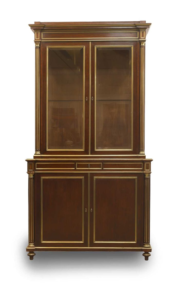 A French mahogany and parcel gilt display cabinet, c. 1900,: A French mahogany and parcel gilt display cabinet, c. 1900, with glazed doors above single long drawer over panelled cupboard doors, opening to reveal a single shelf 113cm wide, 53cm deep, 206cm high