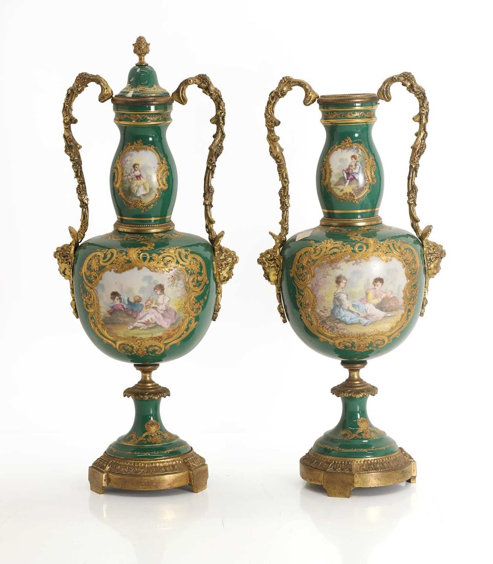 A pair Sevres style vases, 19th century,: A pair Sevres style vases, 19th century, both with deep green ground with opposing pairs of reserves filled with courting and figure scenes, the vase with twin moulded brass handles shaped as grape
