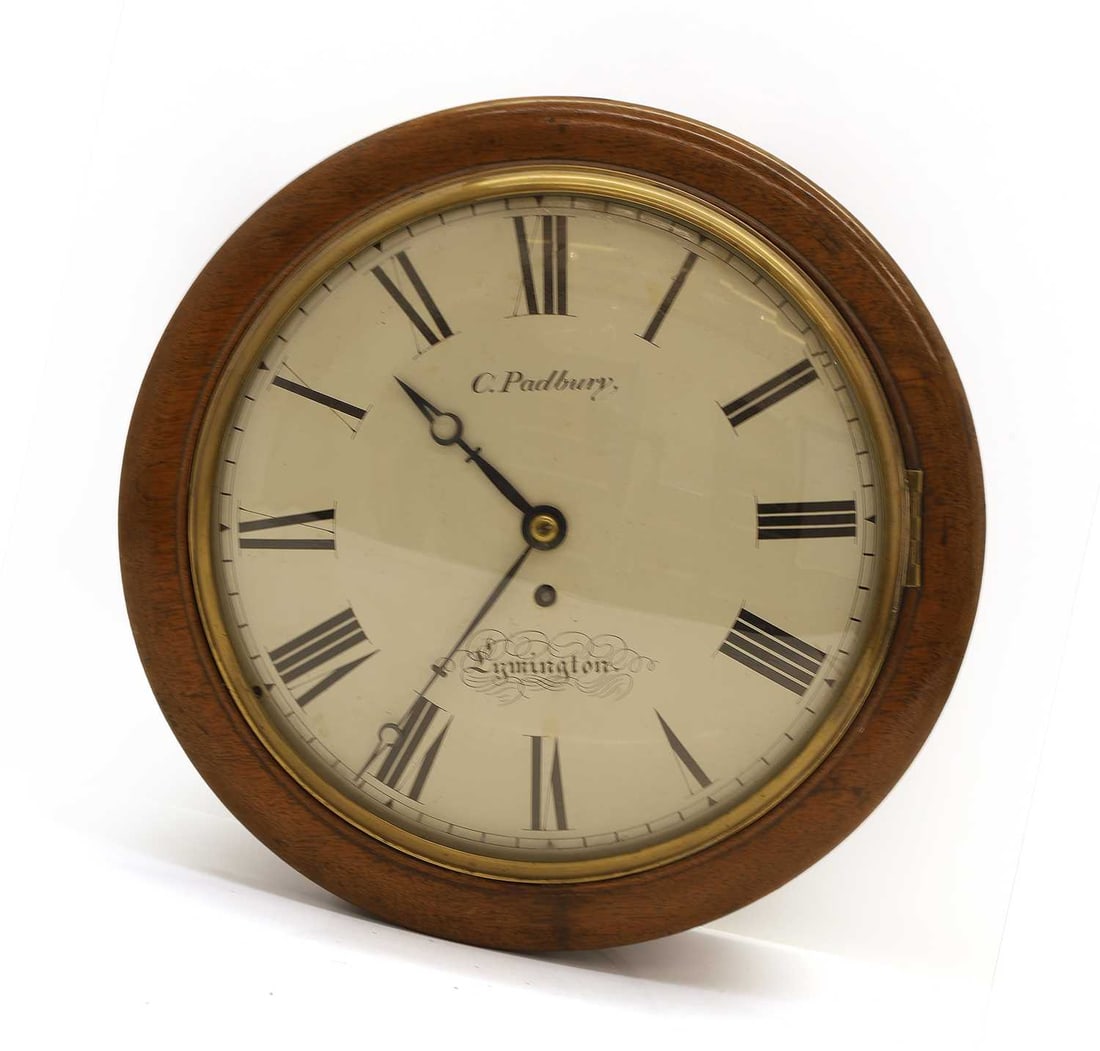 A mahogany dial clock by C. Padbury, Lymington, early 19th century,: A mahogany dial clock by C. Padbury, Lymington, early 19th century, with a cast bezel, the dial with black Roman numerals, the dial inscribed, and glazed convex door, fusee movement 39cm wide, 14cm