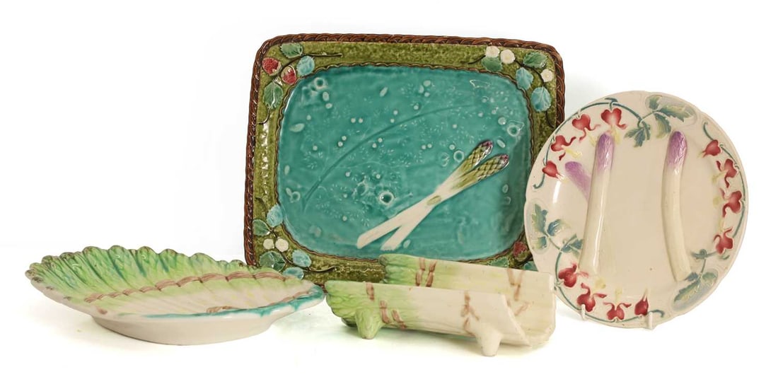 A St Clement asparagus plate, 19th century,: A St Clement asparagus plate, 19th century, together with a French 19th century asparagus plate, French asparagus cradle, and shaped draining plate Serving plate, 33cm wide, 27cm deep, 4