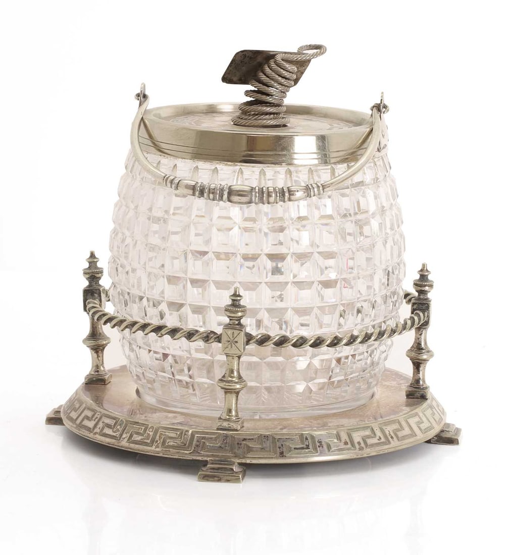 A Edwardian silver plated and glass biscuit barrel, early 20th century,: A Edwardian silver plated and glass biscuit barrel, early 20th century, with greek key decoration and on a rope twist base 18cm wide, 19cm high Condition Report: Tarnishing throughout. Possibly