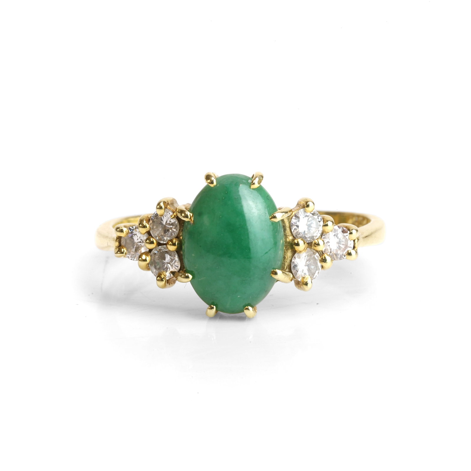 An 18ct gold jade and diamond ring,: An 18ct gold jade and diamond ring, claw set to the centre with an oval cut jadeite cabochon, to a trefoil cluster of round brilliant cut diamonds to either side, with tapered shoulders and a 'D'