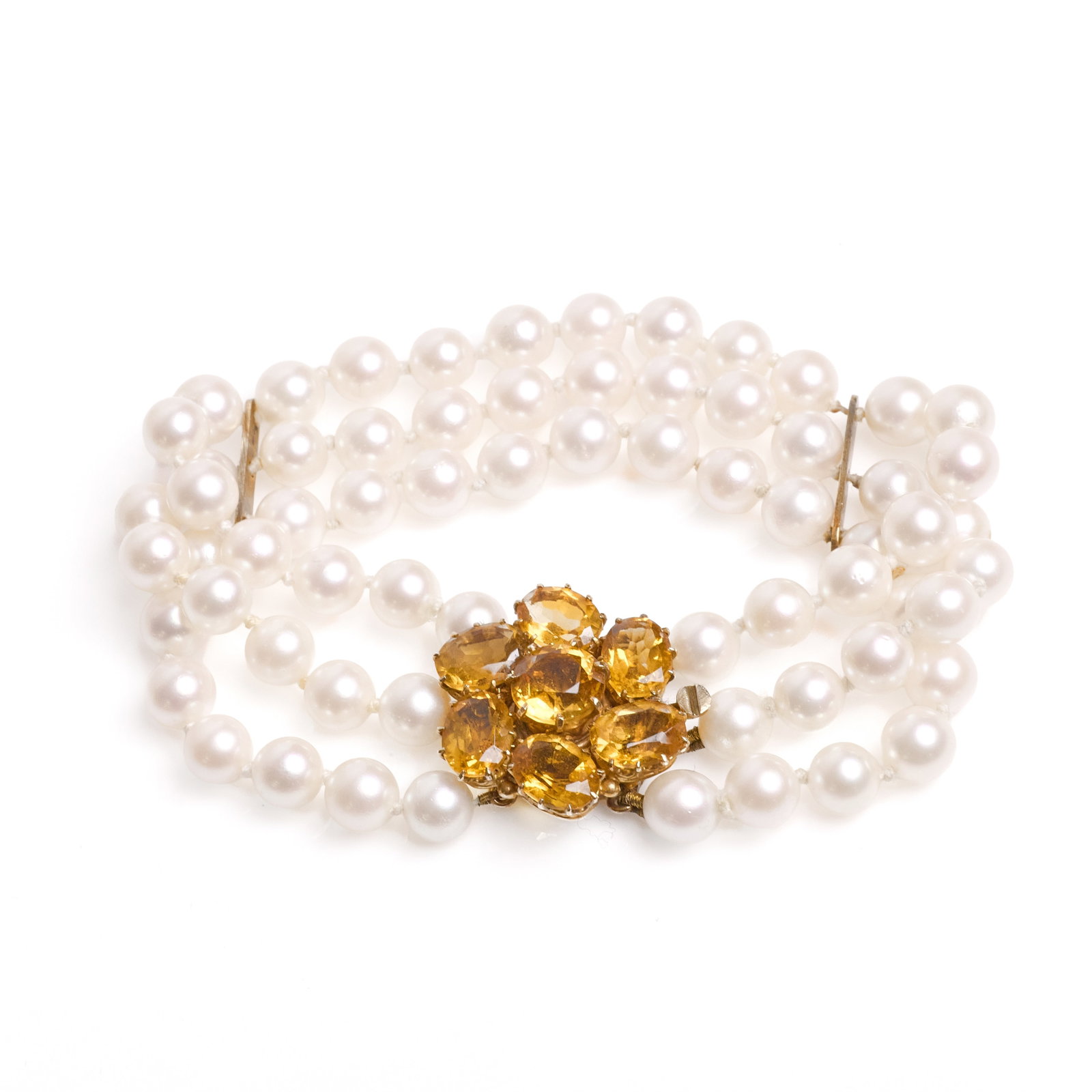 A three row cultured pearl and citrine bracelet,: A three row cultured pearl and citrine bracelet, the uniform cultured pearls, strung knotted with two bars to a cluster box clasp composed of round and oval citrine, stamped 375, tested as