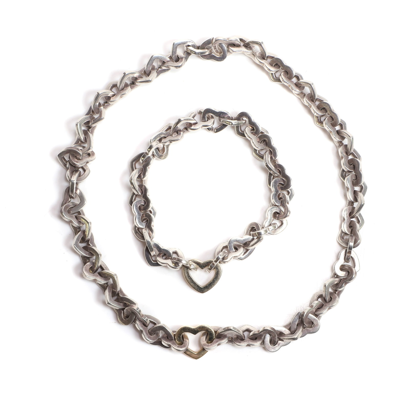 Tiffany & Co., a heart link necklace and bracelet set,: Tiffany & Co., a heart link necklace and bracelet set, the necklace with solid heart-shaped links, to a larger central yellow heart-shaped link, and a matching bracelet, both stamped 925 750, London 2