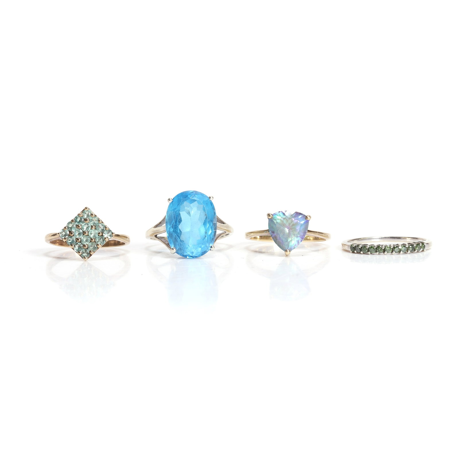 A group of four gemstone set rings,: A group of four gemstone set rings, to include a 9ct gold trillion 'mystic' topaz single stone ring, Birmingham 2006, a 9ct gold alexandrite ring, Birmingham 2006, a single stone oval blue topaz,