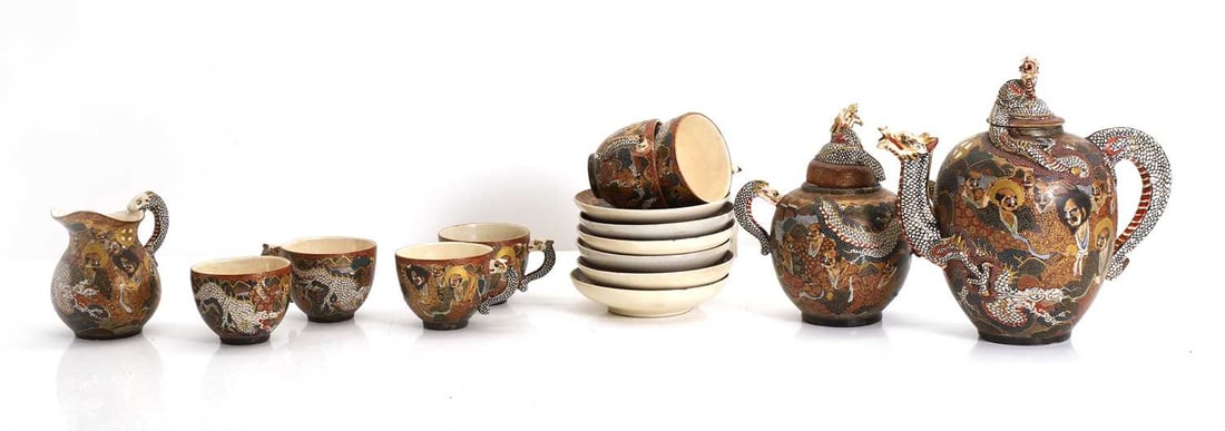 A Japanese Satsuma tea service, 19th / 20th century,: A Japanese Satsuma tea service, 19th / 20th century, comprising of fifteen pieces, including teapot, handled jar and cover, cream jug, six teacups and saucers, with a 1000 faces pattern, the handles m