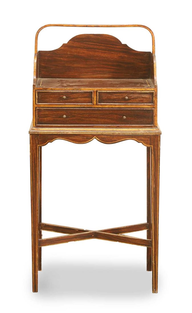A Regency-style simulated rosewood cheveret, 20th century,: A Regency-style simulated rosewood cheveret, 20th century, with raised gallery and carry handle over a arrangement of drawers, on square tapering legs united by x stretcher 43cm wide, 23cm deep, 92cm