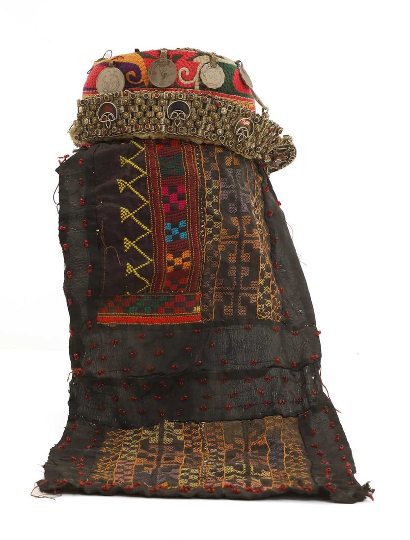 A Kyrgyz long tail hat,: A Kyrgyz long tail hat, embroidered and metal mounted 20cm diameter, 50cm long Provenance: Provenance: The Museum of Applied Arts, Tashkent, Uzbekistan; purchased from the above by the current