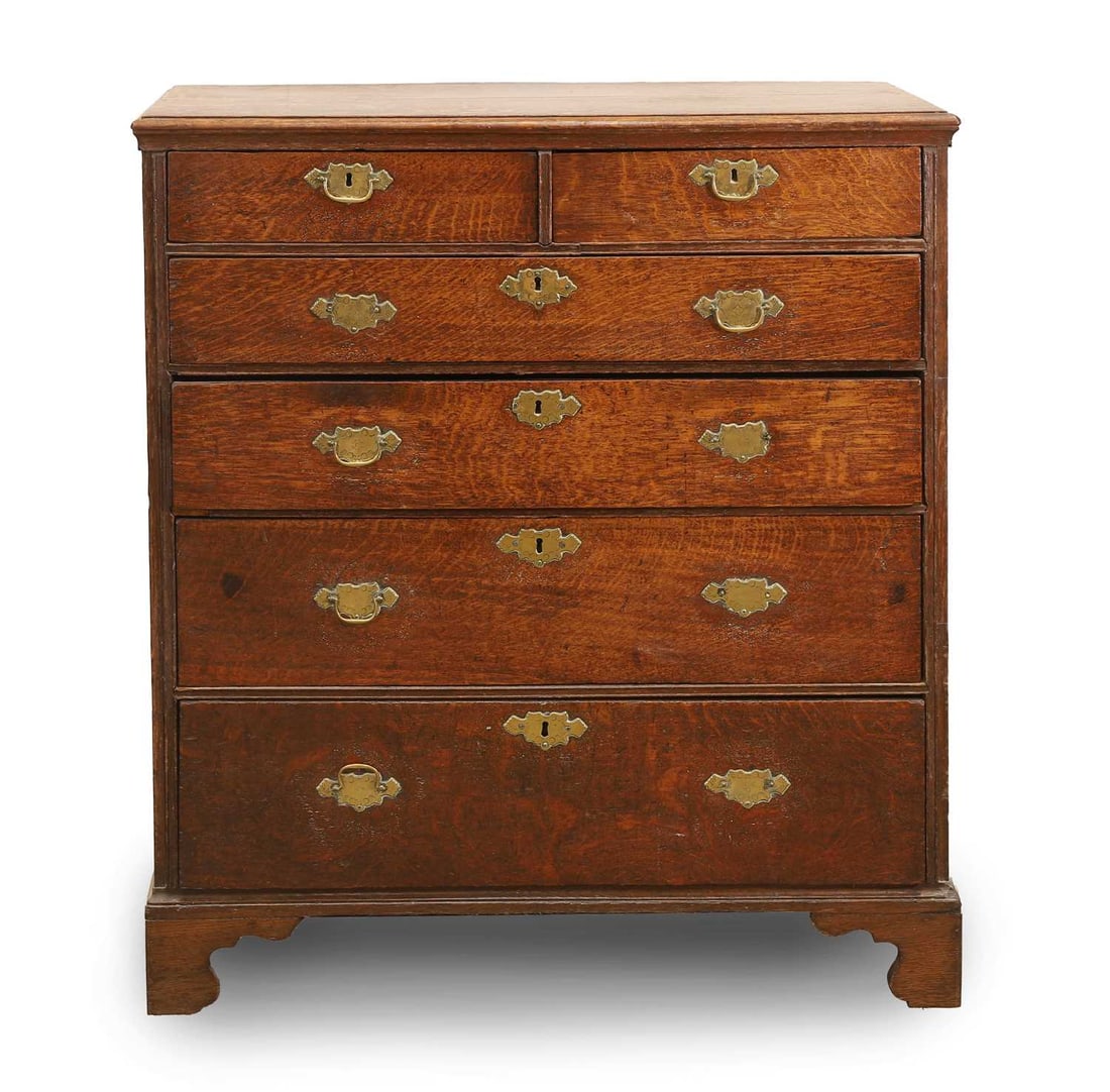 A George III oak chest, 18th century,: A George III oak chest, 18th century, consisting of two short and four long drawers, with brass handles with pulls, the brass shaped escutcheons engraved, on bracket feet 94cm wide, 50.5cm wide, 107cm