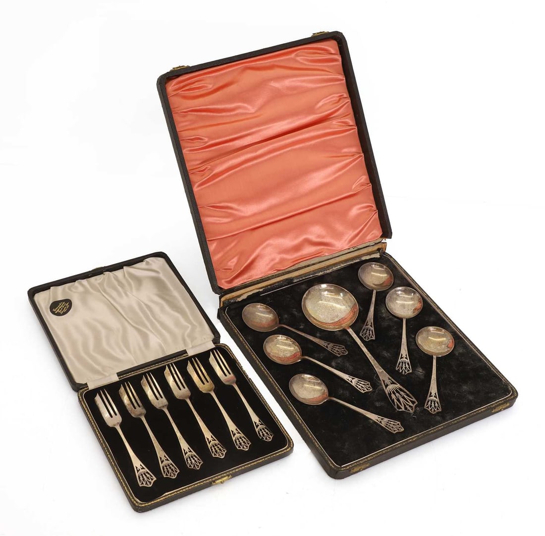A set of cased silver fruit spoons with pierced decoration,: A set of cased silver fruit spoons with pierced decoration, by Lanson Ltd, Birmingham, 1945, six smaller spoons and one serving spoon, together with a matching set of cake forks, 1944, all with pierce