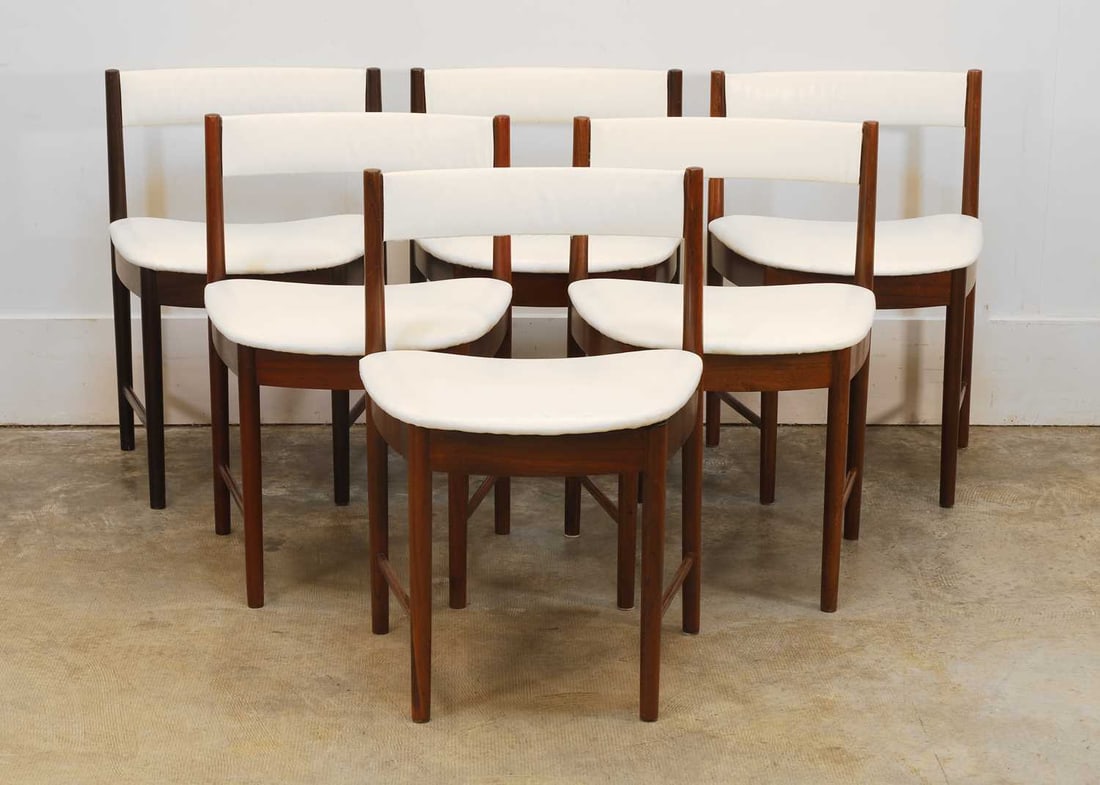 Six Mackintosh teak chairs, 20th century,: Six Mackintosh teak chairs, 20th century, with white vinyl upholstery, upright supports and tapering seats, two darker than the rest 49cm wide, 71cm high 6