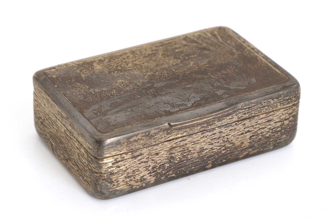 A Russian silver and niello box, late 19th century,: A Russian silver and niello box, late 19th century, an engraved landscape scene featuring deer within a clearing, surrounded by a treeline, the interior lined 6.5cm wide,