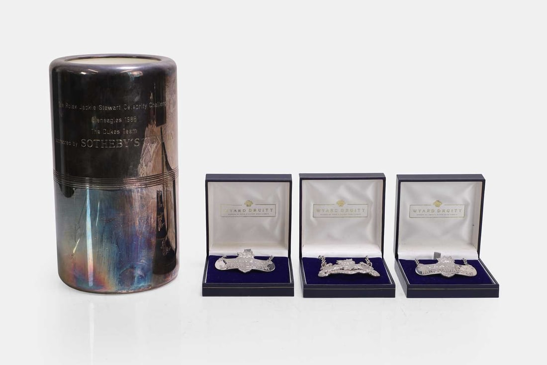 Three silver wine labels, by Wyard Druitt & Co. Ltd., Birmingham, two 2004, one 2003,: Three silver wine labels, by Wyard Druitt & Co. Ltd., Birmingham, two 2004, one 2003, together with a Christofle silver-plated wine cooler, engraved 'The Rolex Jackie Stewart Celebrity