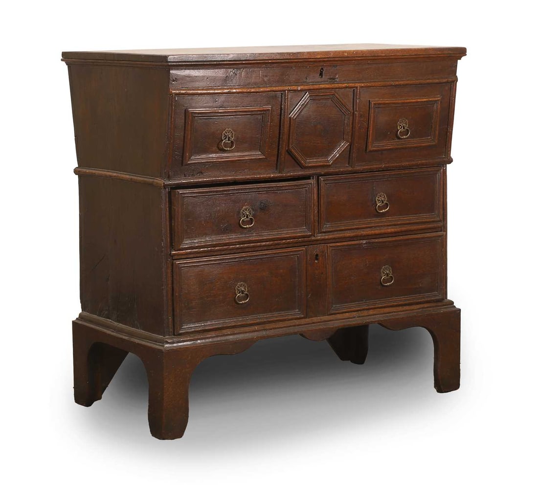 A Charles II oak chest of drawers, late 17th century,: A Charles II oak chest of drawers, late 17th century, the canted top with opening to the top over two short and one long geometric moulded drawers 87cm wide, 50cm deep, 86.5cm high Condition Report: