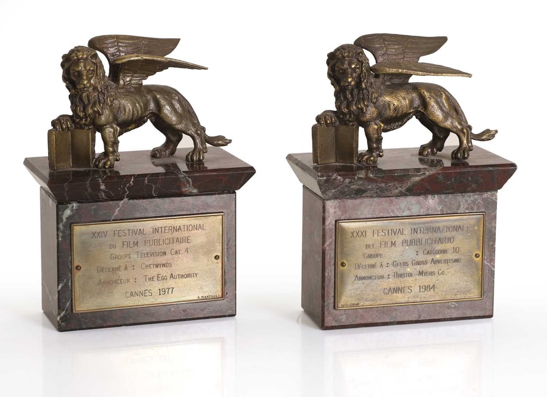 A pair of Cannes Festival Internazionale trophies,: A pair of Cannes Festival Internazionale trophies, Cannes XXIV and XXXI Festival Internazionale 1977 and 1984 trophies, in the form of the Lion of Venice, on a marble base, with a metal presentation