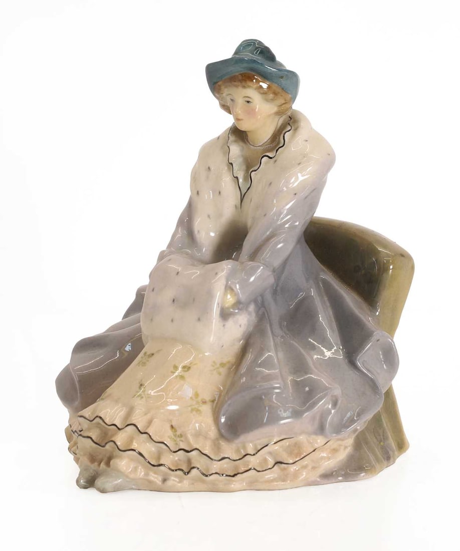 An early Doulton Co figure,: An early Doulton Co figure, Lady of the Ermine Muff by E W Light, the base with marks and inscription 16cm wide, 18.5cm high Condition Report: Head has been off before and reattached with glue.