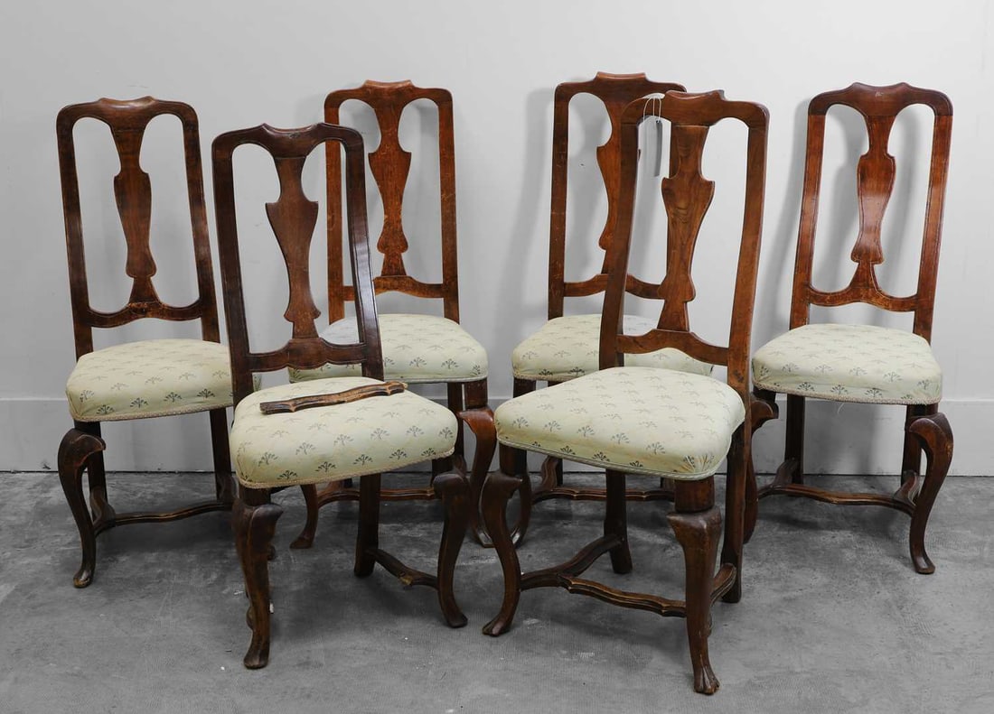 A set of six Queen Anne style walnut dining chairs, late 18th to early 19th century,: A set of six Queen Anne style walnut dining chairs, late 18th to early 19th century, each with a shaped toprail above a vase-shaped splat, with an overstuffed upholstered seat, raised on cabriole