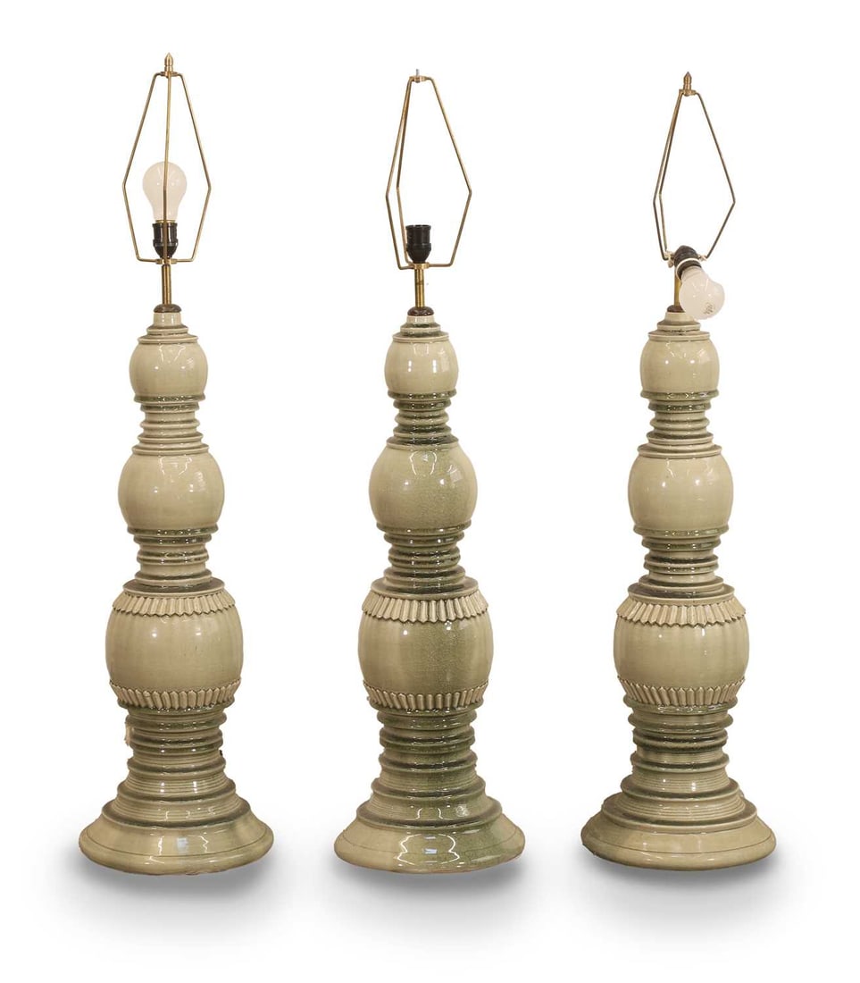 A collection of three Asian style lamps, of modern manufacture,: A collection of three Asian style lamps, of modern manufacture, of shaped form and circular base 27cm wide, 86cm high 3 Condition Report: One with a broken fitting to the top section. Crazing to the