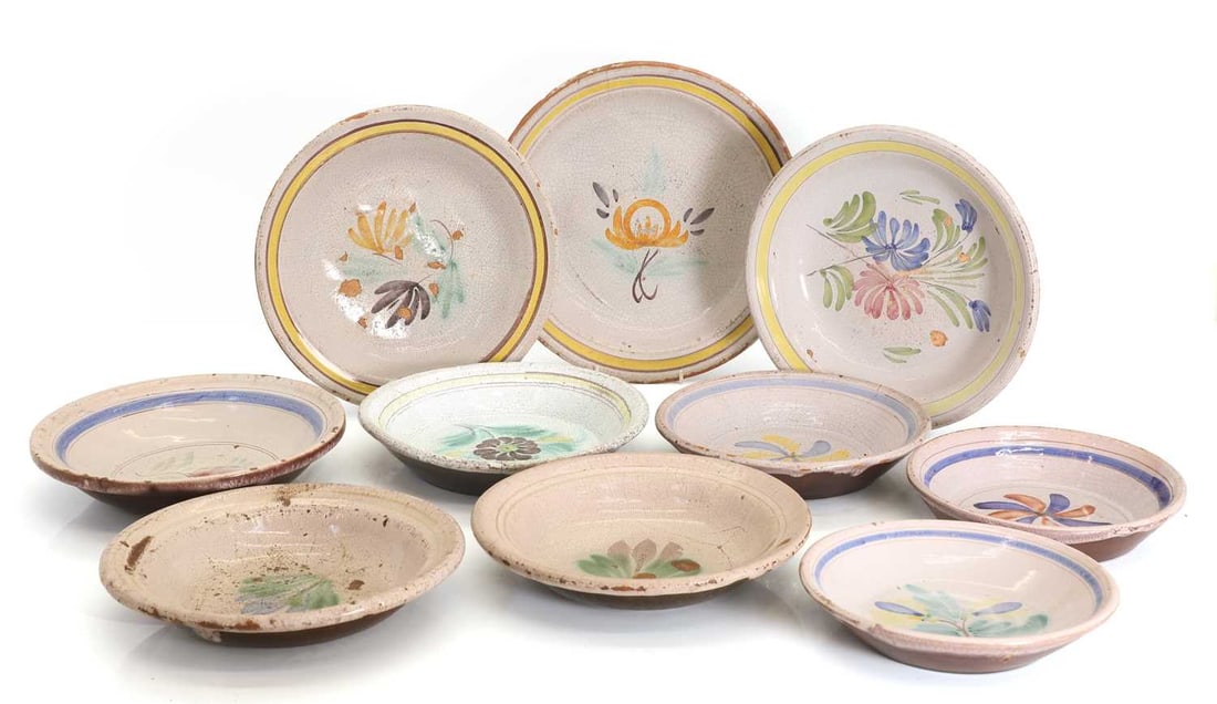 A collection of French majolica-style plates 18th and 19th century,: A collection of French majolica-style plates 18th and 19th century, all with ivory ground decorated with floral motifs to the centre Largest 30cm wide 10 Condition Report: Crazing to the glaze