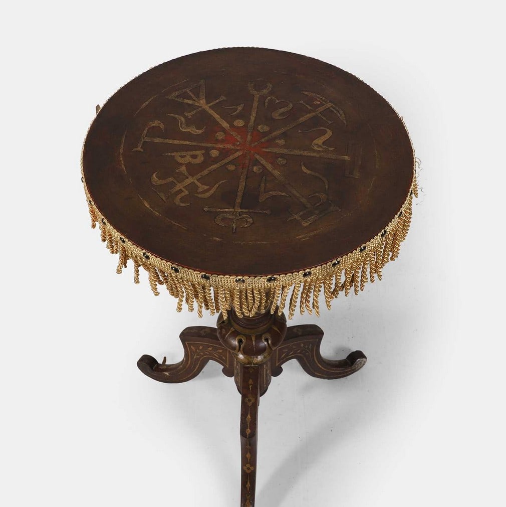 A 'gypsy' tripod table, late 19th century,: A 'gypsy' tripod table, late 19th century, with later painted gilt details of occult and mystical symbols, the edge mounted with a tasselled fringe (45cm diameter, 70cm high) Condition Report: Painted