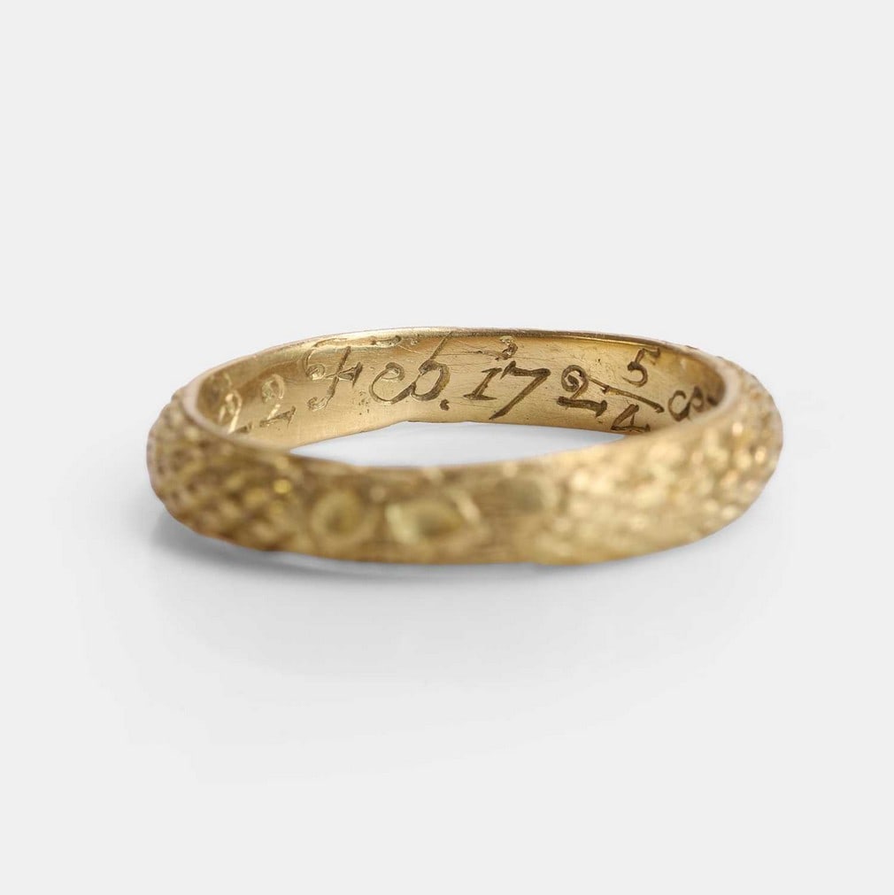 A memento mori gold skull ring, 18th century,: A memento mori gold skull ring, 18th century, with chased scales and skull, engraved to the inside of the shank 'SM of 22 Feb 1724/5 Oct 6 4 Month', with maker’s mark (20mm overall, internal dia