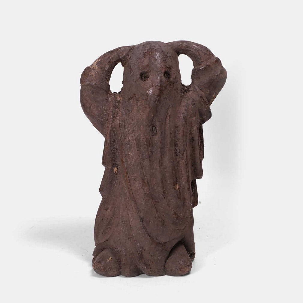 A spooky carved wooden ghost sculpture, late 19th century,: A spooky carved wooden ghost sculpture, late 19th century, an unusual, bizarre and spooky, carved wooden sculpture of a ghost figure with arms aloft (20cm wide, 13cm deep, 30cm high) Condition Report: