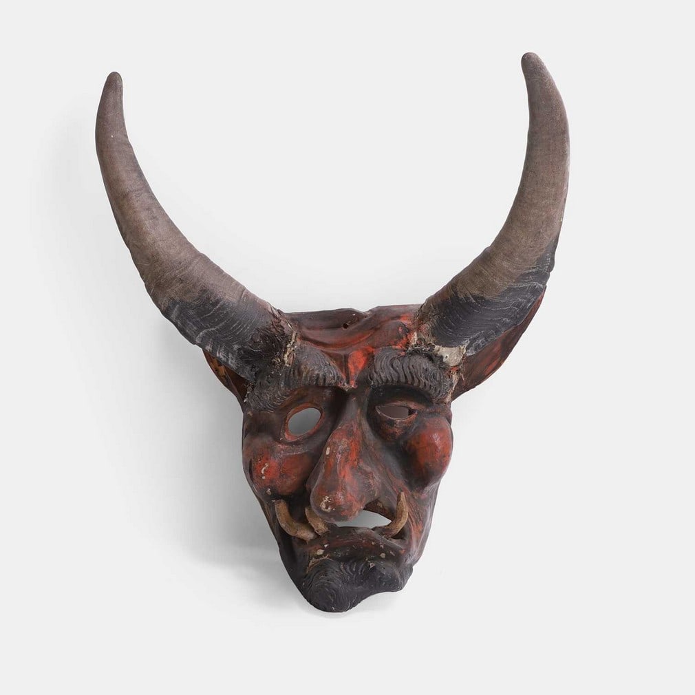 A Mexican Guanajuato Diablo mask, 20th century,: A Mexican Guanajuato Diablo mask, 20th century, carved and painted, with applied horns and composite moulded tusks (39cm wide, 30cm deep, 54cm high) Condition Report: With wear, losses
