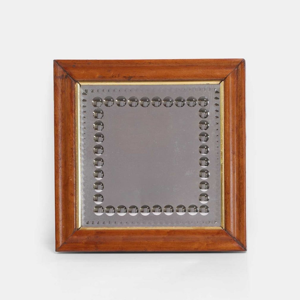 A Victorian sorcerer's mirror, 19th century,: A Victorian sorcerer's mirror, 19th century, the square plate with numerous roundels and an engraved border, in a maple frame (plate 23 x 23cm; framed 31 x 31cm) Condition Report: Very minor foxing