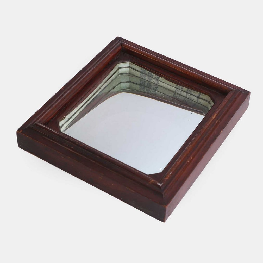 A mysterious concave illusion mirror, late 19th or early 20th century,: A mysterious concave illusion mirror, late 19th or early 20th century, with unusual stamped text and pictograms to the upper inner edge, in a moulded wood frame (19cm wide, 20.5cm high) Condition