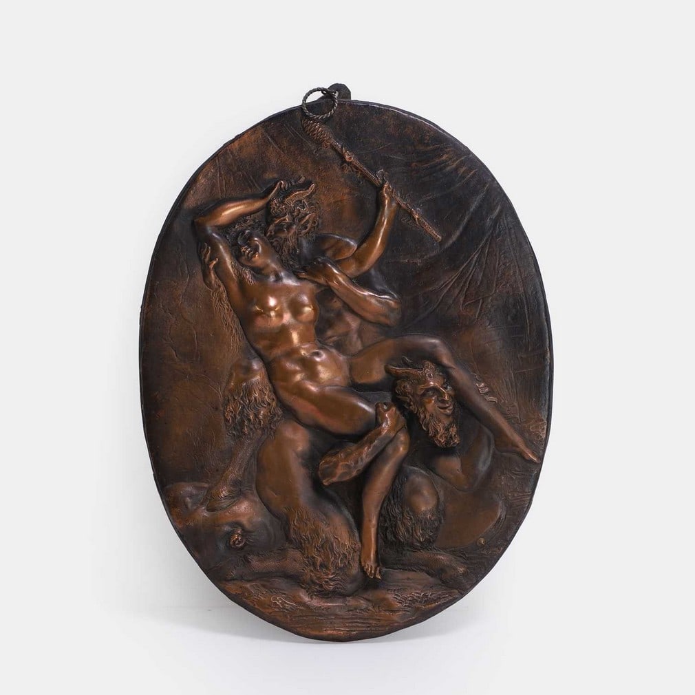 After Claude Michel called 'Clodion', late 19th century,: After Claude Michel called 'Clodion', late 19th century, an oval cast copper plaque, depicting two satyrs molesting a nymph (26 x 20cm) Condition Report: Some rubbing to the patina - fair overall.