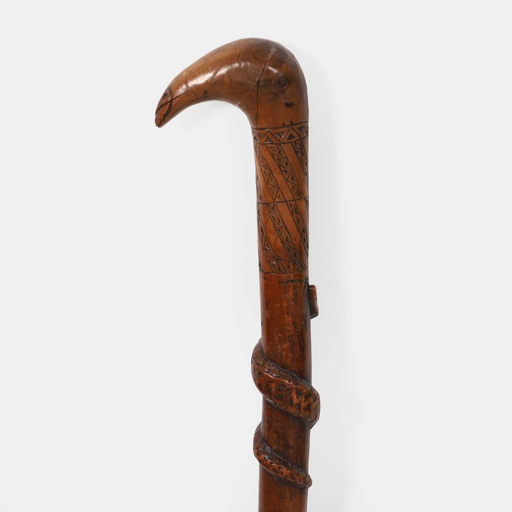 An Occultist carved wood walking stick, late 19th century,: An Occultist carved wood walking stick, late 19th century, modelled with three serpents trailing around the shaft, with a spiral carved collar, the handle carved as another serpent's head, with a meta