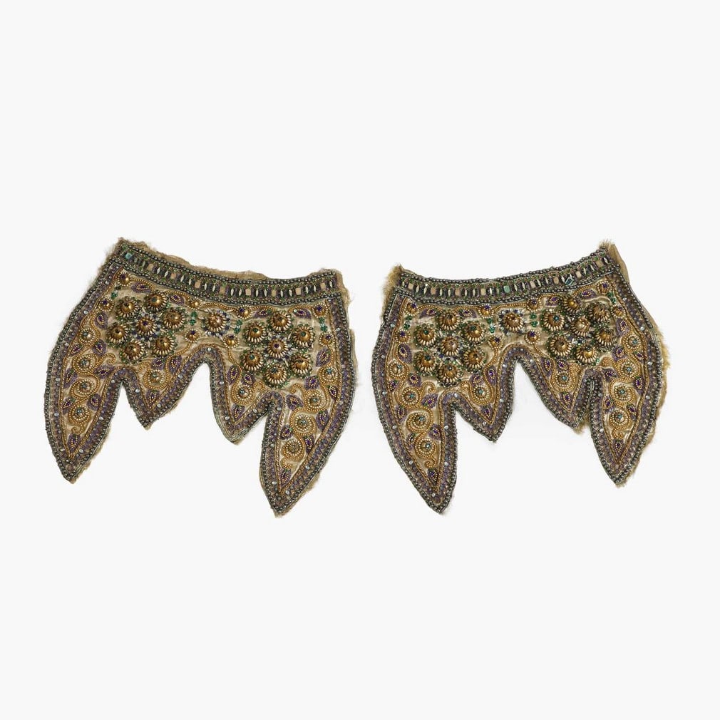 A pair of bejewelled and embroidered silk elephant panels, 20th century, Indian,: A pair of bejewelled and embroidered silk elephant panels, 20th century, Indian, each of shaped form, with gold, purple, and turquoise threads, and mounted with faux pearls and jewels (38 x 44cm) (2) 