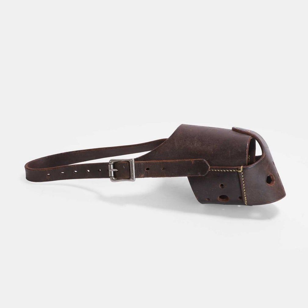 A Wormwood Scrubs dog muzzle circa 1960s,: A Wormwood Scrubs dog muzzle circa 1960s, stamped 'HMP' and 'W' in a circle (36.5cm long) Condition Report: No damage detected.
