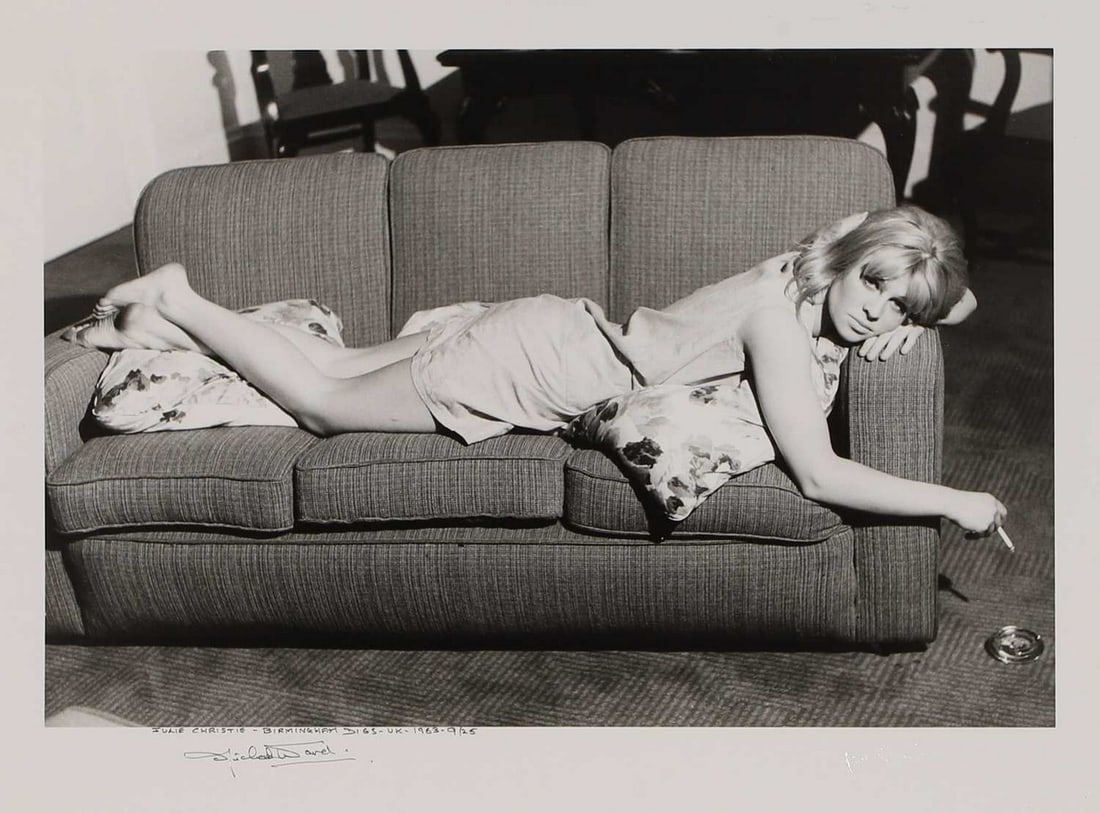 ▲ Michael Ward (British, 1929-2011) 'Julie Christie, Birmingham Digs, 1963': ▲ Michael Ward (British, 1929-2011) 'Julie Christie, Birmingham Digs, 1963' an archival pigment print photograph, of Julie Christie lying on a sofa with a cigarette, printed later, signed 'Micha