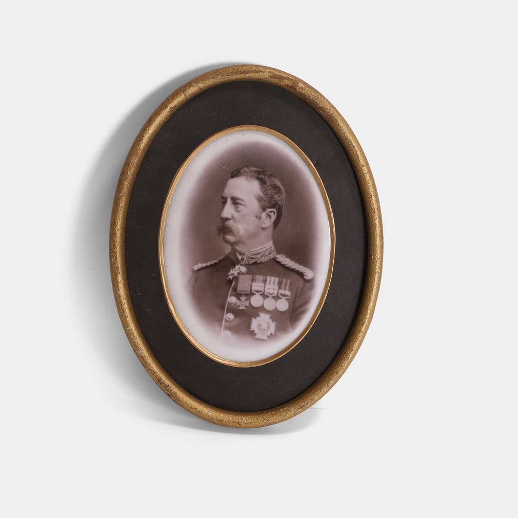 An oval porcelain plaque of a Victoria Cross medal recipient, early 20th century,: An oval porcelain plaque of a Victoria Cross medal recipient, early 20th century, the lithographed oval panel, mounted and framed (15 x 11cm; framed 21.5 x 16.5cm) Footnote: Believed to depict General