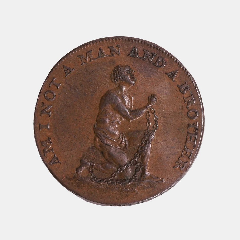 A William Lutwyche Anti-Slavery Society halfpenny token, circa 1795,: A William Lutwyche Anti-Slavery Society halfpenny token, circa 1795, depicting a shackled African slave kneeling and the text 'Am I not a man and a brother', the reverse depicts two hands clasped and 