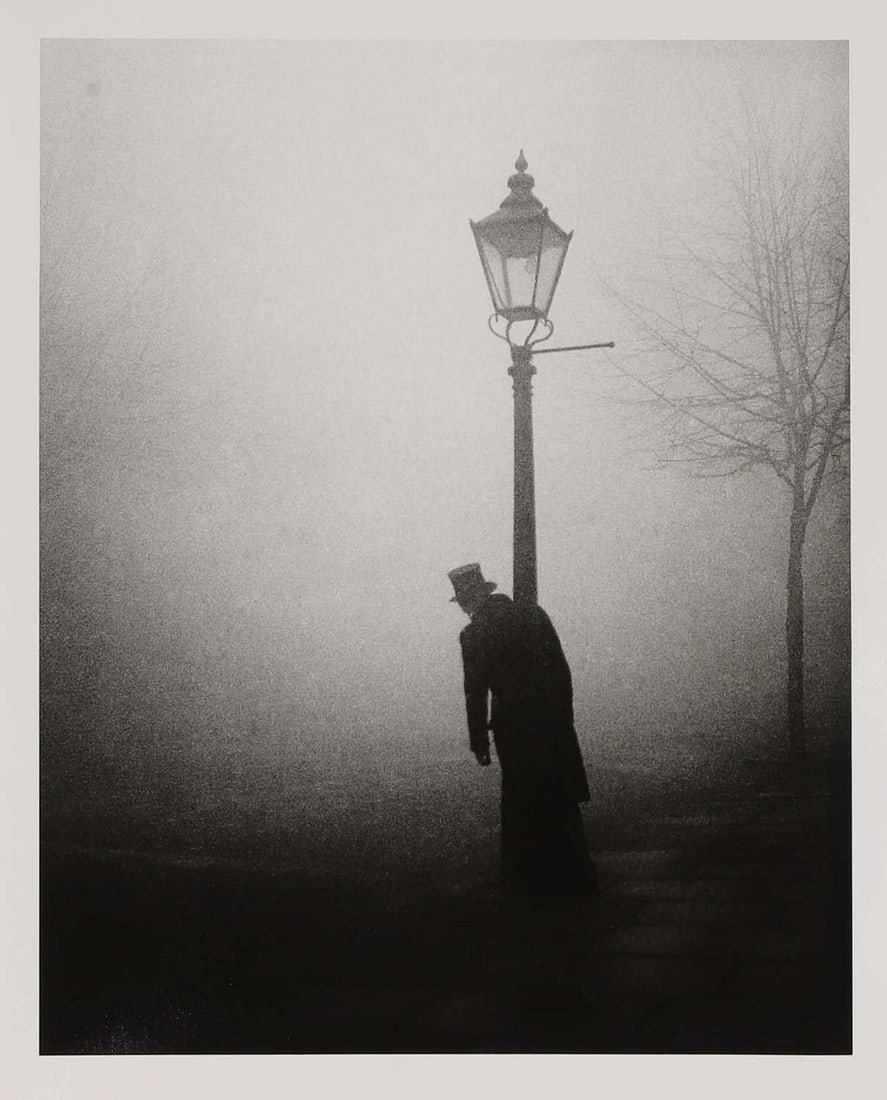 ▲ Bill Brandt (British, 1904-1983) 'After the celebration, London, 1934': ▲ Bill Brandt (British, 1904-1983) 'After the celebration, London, 1934' a gelatin silver print, of a man leaning on a lamp post, printed later, numbered 2/35 and stamped with the estate stamp v