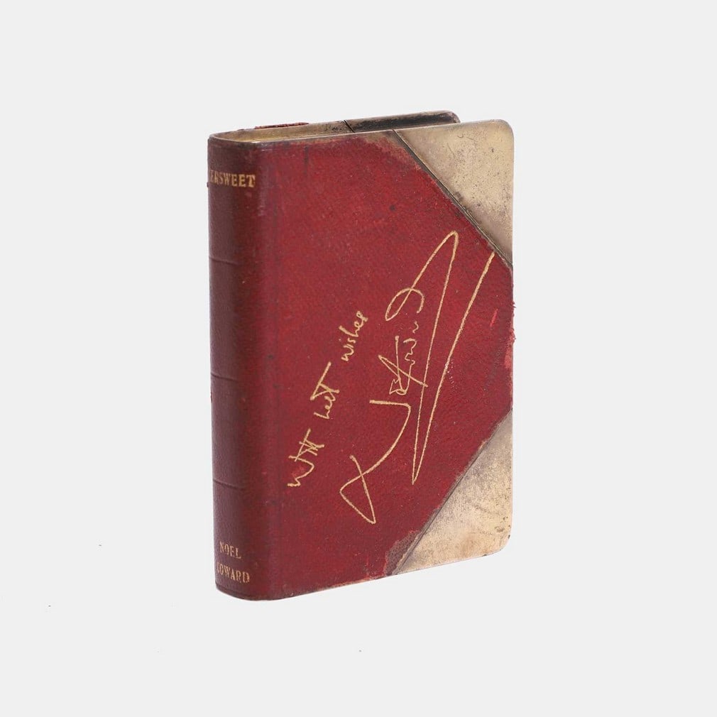 Of Noël Coward interest: a rare Prohibition gilt-metal and leather-mounted novelty spirit: Of Noël Coward interest: a rare Prohibition gilt-metal and leather-mounted novelty spirit flask, circa 1930, commemorating the play 'Bitter Sweet' by Noël Coward, inscribed and gilt-embossed