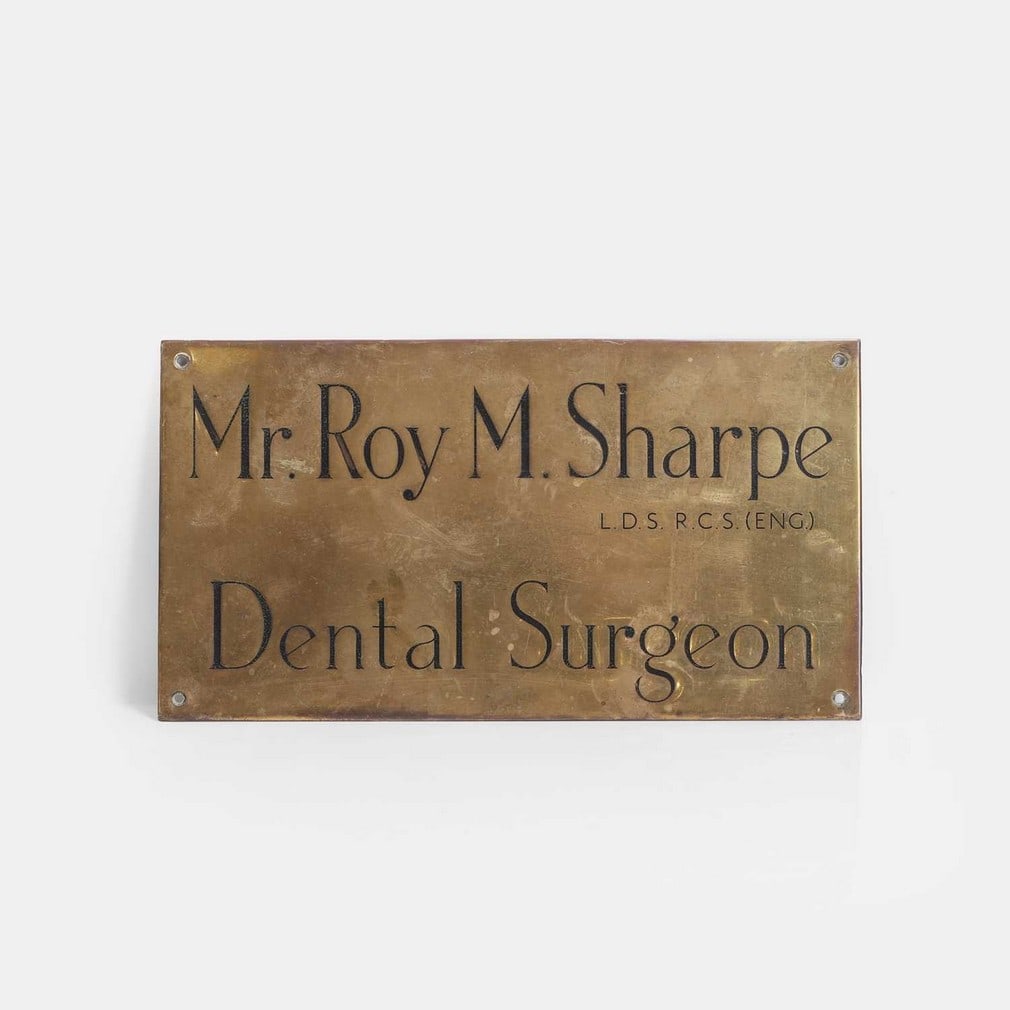 A dentist's brass and enamelled name plaque, early 20th century, (1 of 2)
