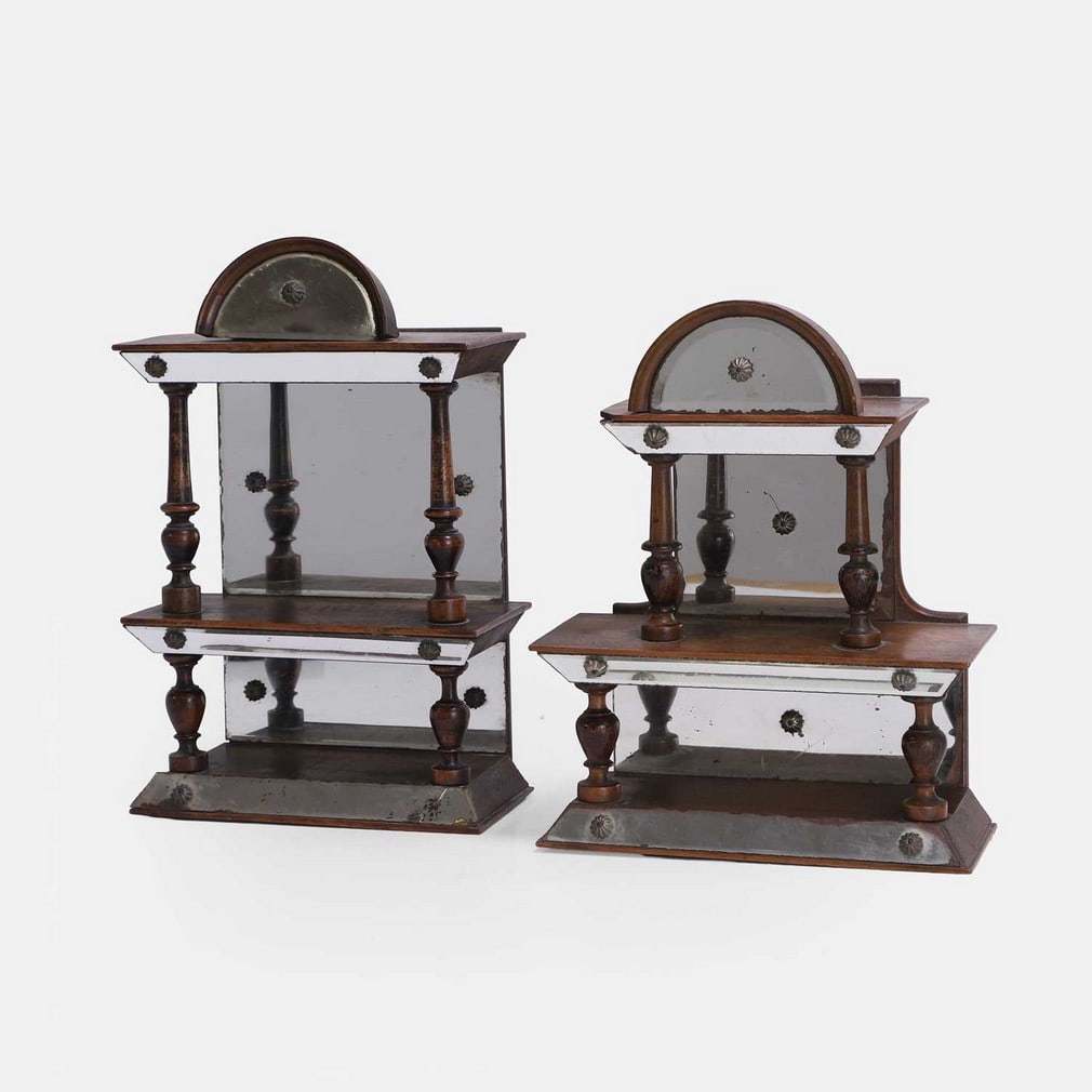 Two wood and mirrored grotto shelves, 19th century,: Two wood and mirrored grotto shelves, 19th century, each shelf has two tiers with turned wooden supports and mirrored panels (19cm wide, 10cm deep, 30cm high, and 21cm wide, 9cm deep, 26cm high) (2) C